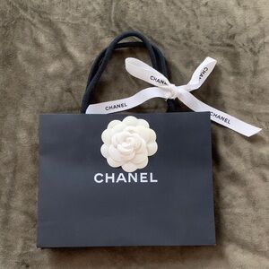 Authentic Chanel Black Paper Bag with White Camelia